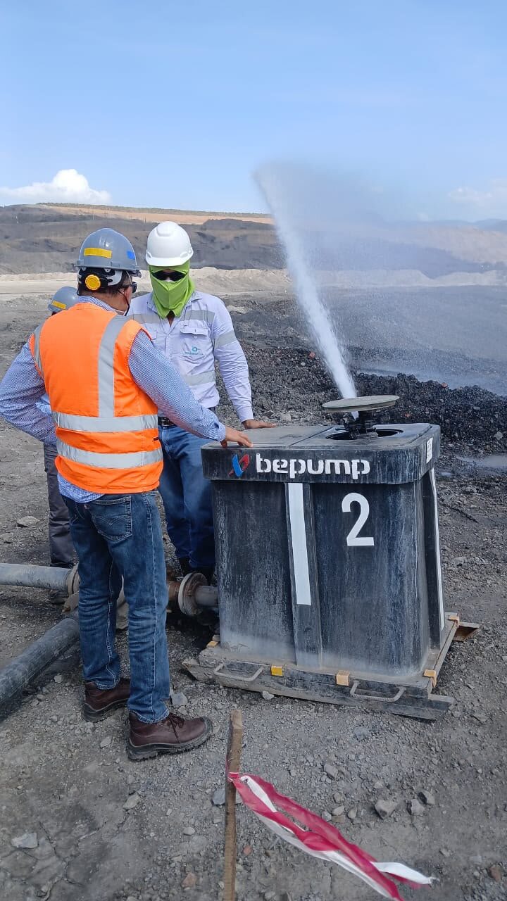 Dewatering pump spraying water inside an open-pit mine in Cesar, Colombia